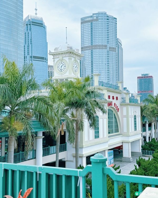 中環碼頭係打卡熱點，因為呢度有壯觀嘅維港美景，背後係高樓大廈...