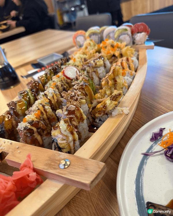 A big boat of sushi rolls, a p...